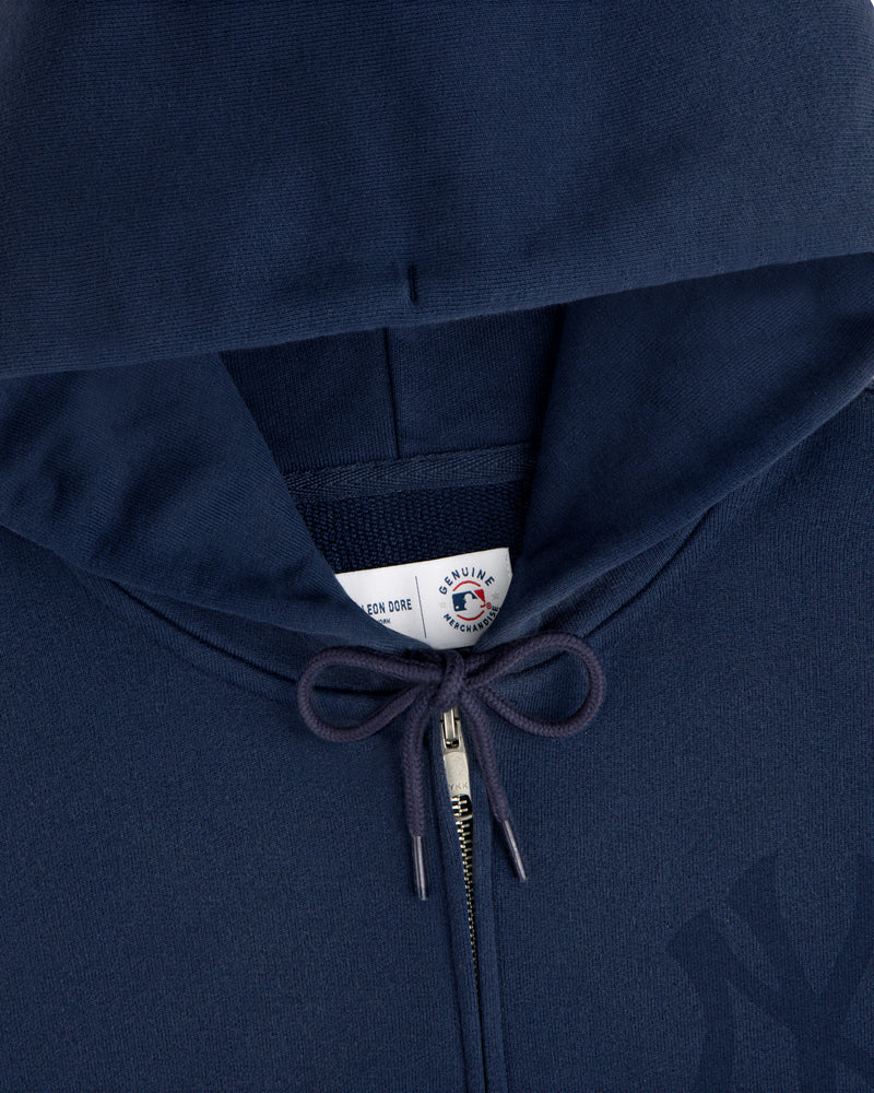 Yankees Washed Full-Zip Hoodie in navy blue with drawstrings and a visible collar tag under the hood.