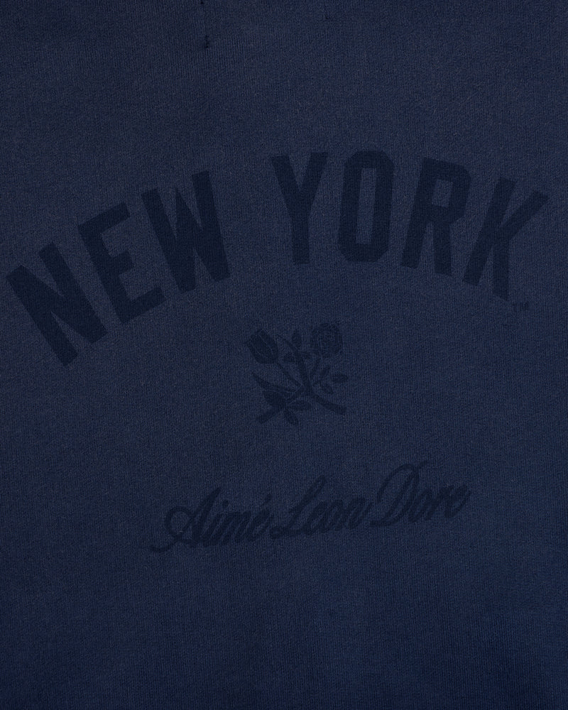 Navy Yankees Washed Full-Zip Hoodie with NEW YORK, rose graphic, and Aimé Leon Dore below.