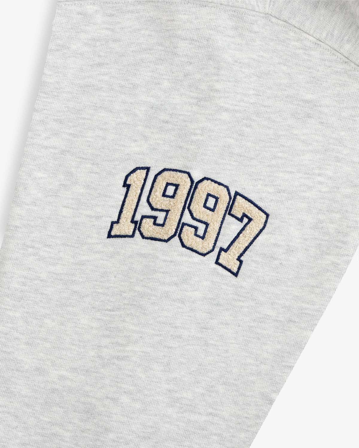 Mulberry Letterman Hoodie in gray with “1997” beige embroidery outlined in black on the fabric.