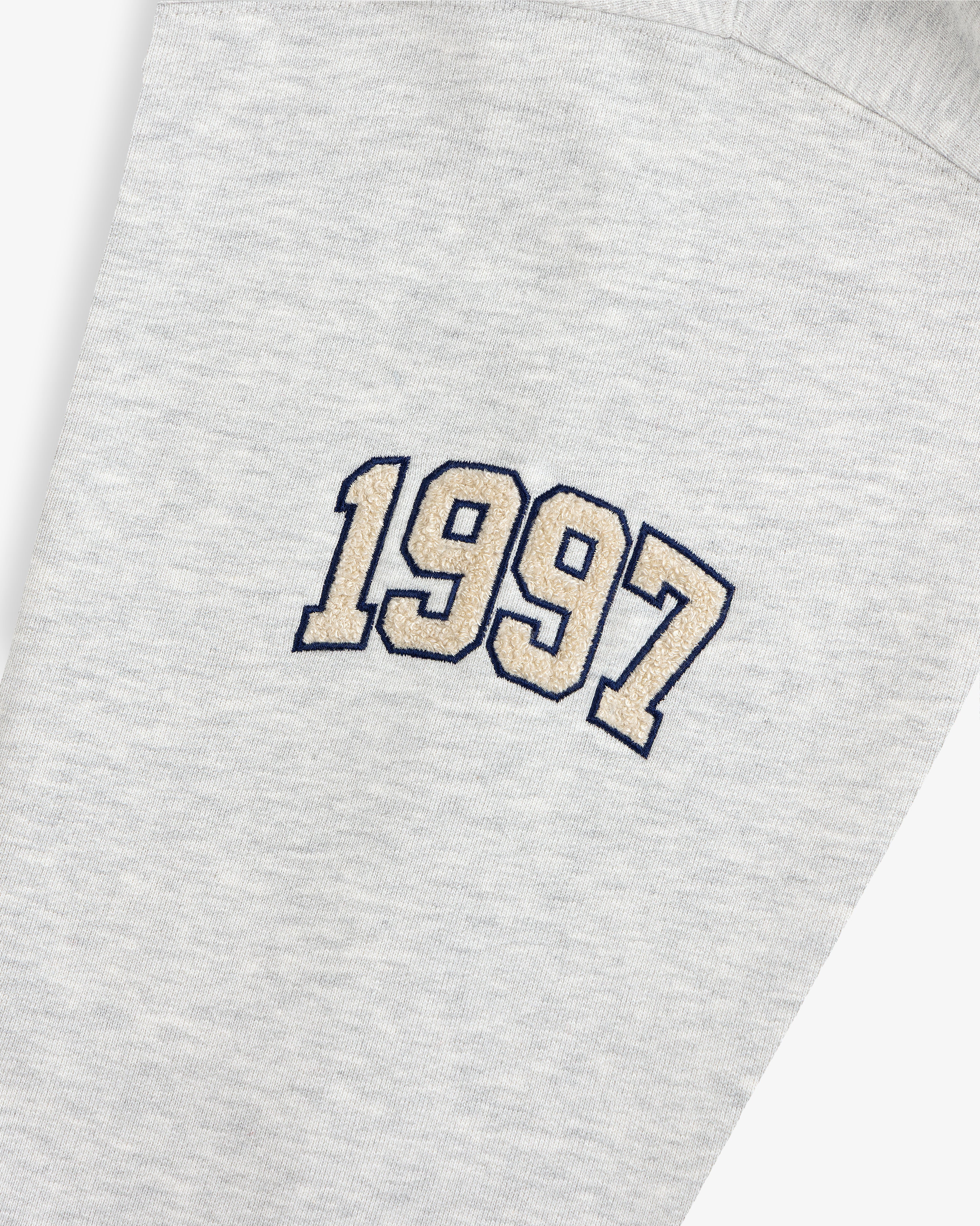 Mulberry Letterman Hoodie in gray with “1997” beige embroidery outlined in black on the fabric.