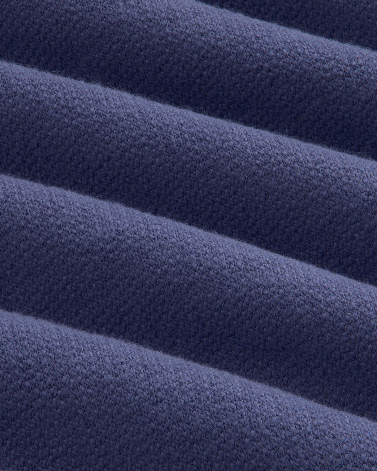 Close-up of soft, navy Stone Washed Marina Hoodie fabric with textured ridges and subtle woven detail.