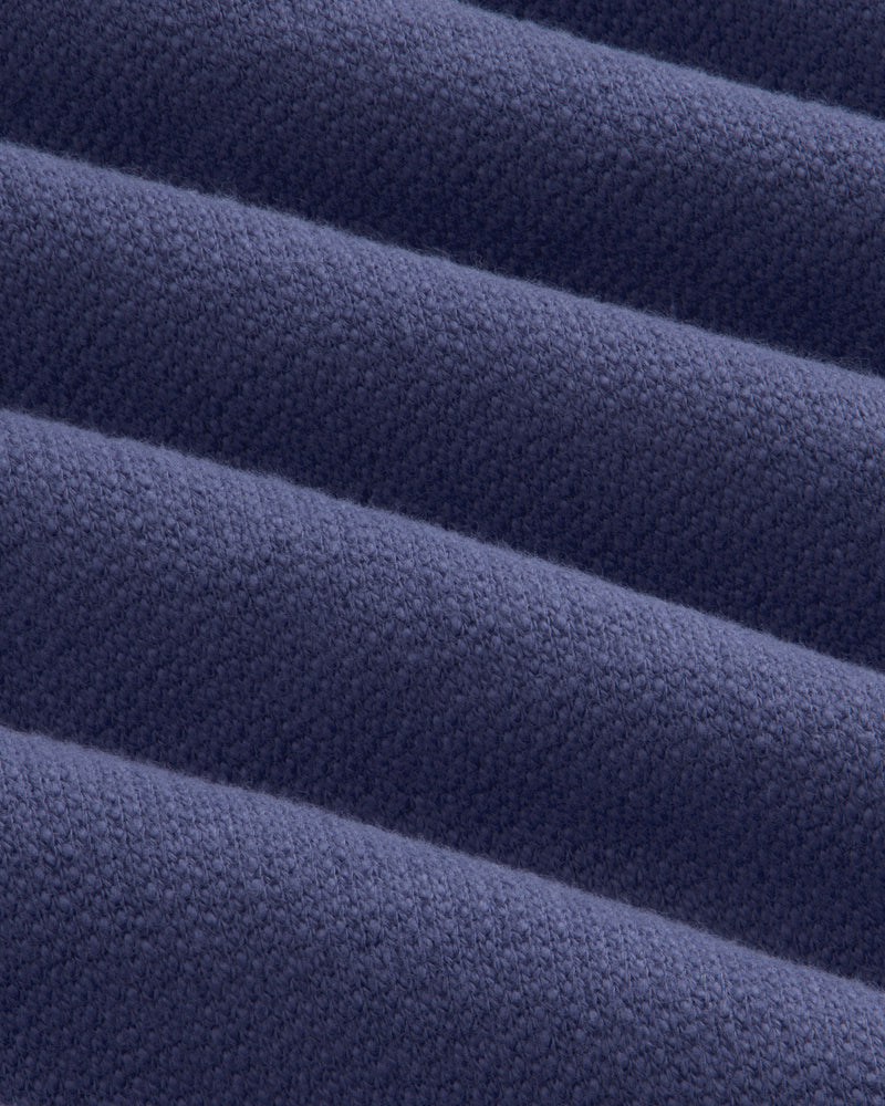 Close-up of Stone Washed Marina Sweatpants: folded dark blue fabric with textured weave and soft, raised ridges.
