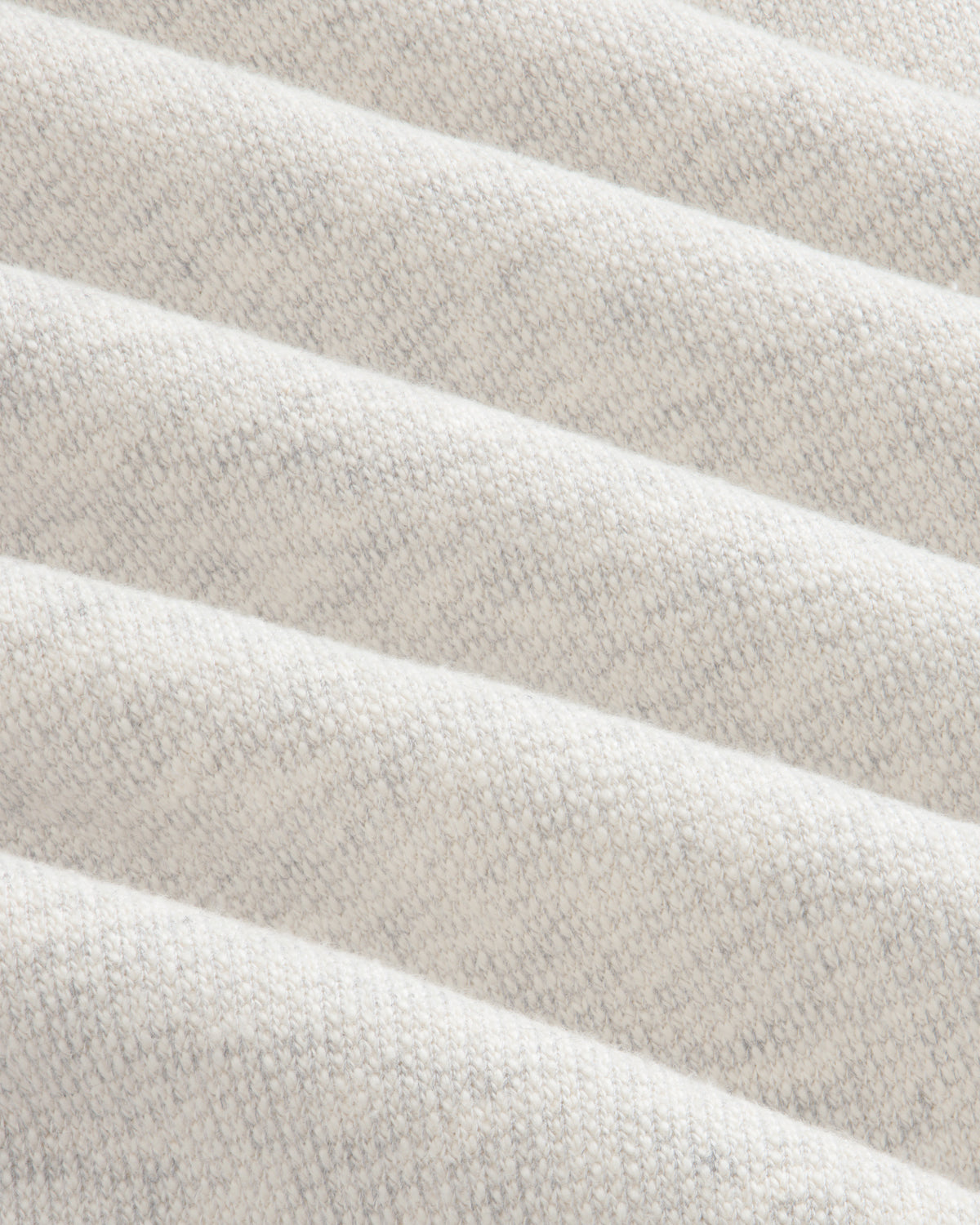 Close-up of the Stone Washed Marina Hoodie’s soft, cream fabric with subtle diagonal ridges and a knit texture.
