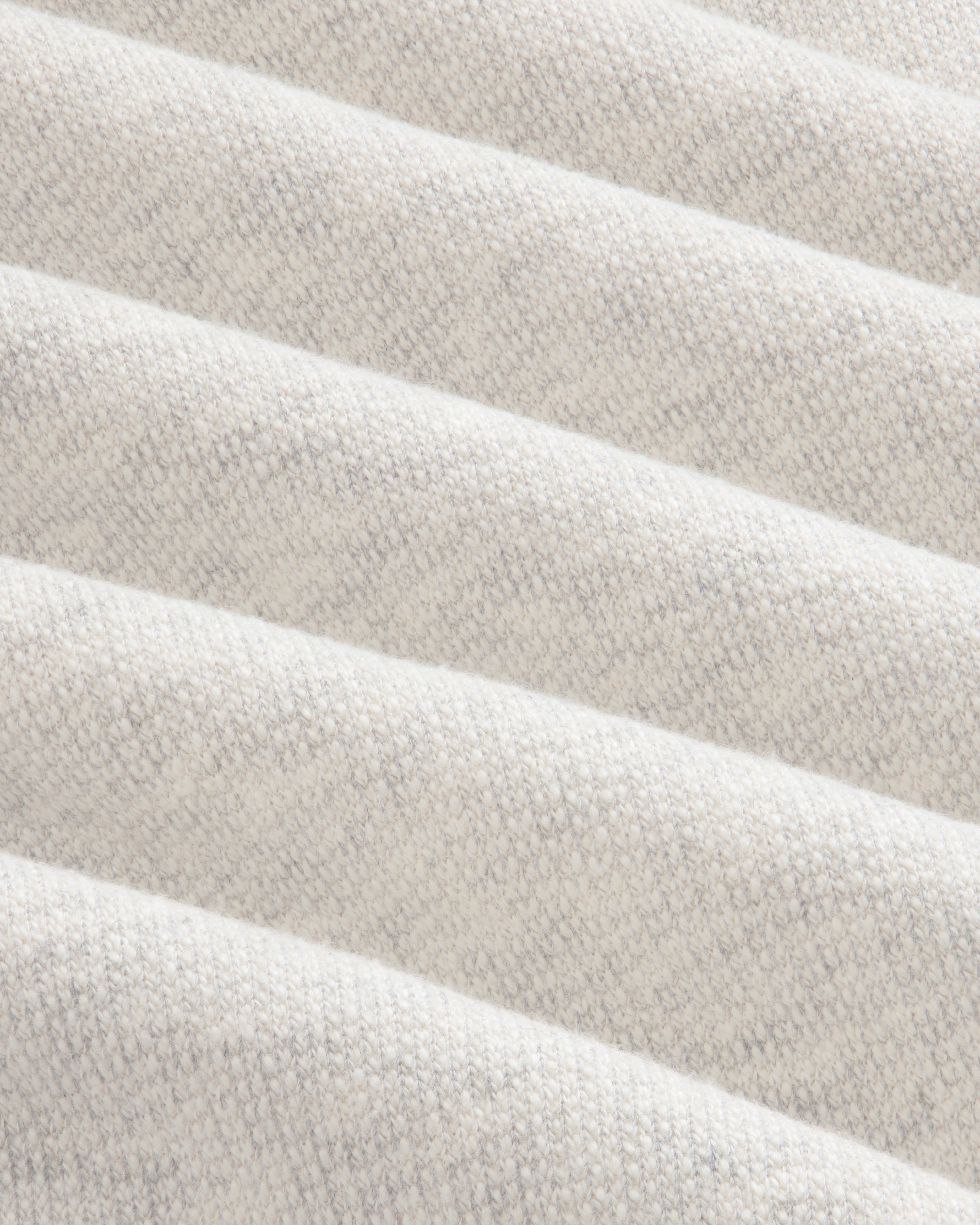 Close-up of the Stone Washed Marina Hoodie’s soft, cream fabric with subtle diagonal ridges and a knit texture.