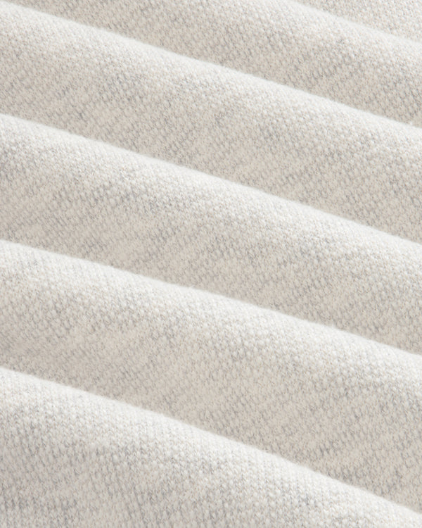 Close-up of the Stone Washed Marina Hoodie’s soft, cream fabric with subtle diagonal ridges and a knit texture.