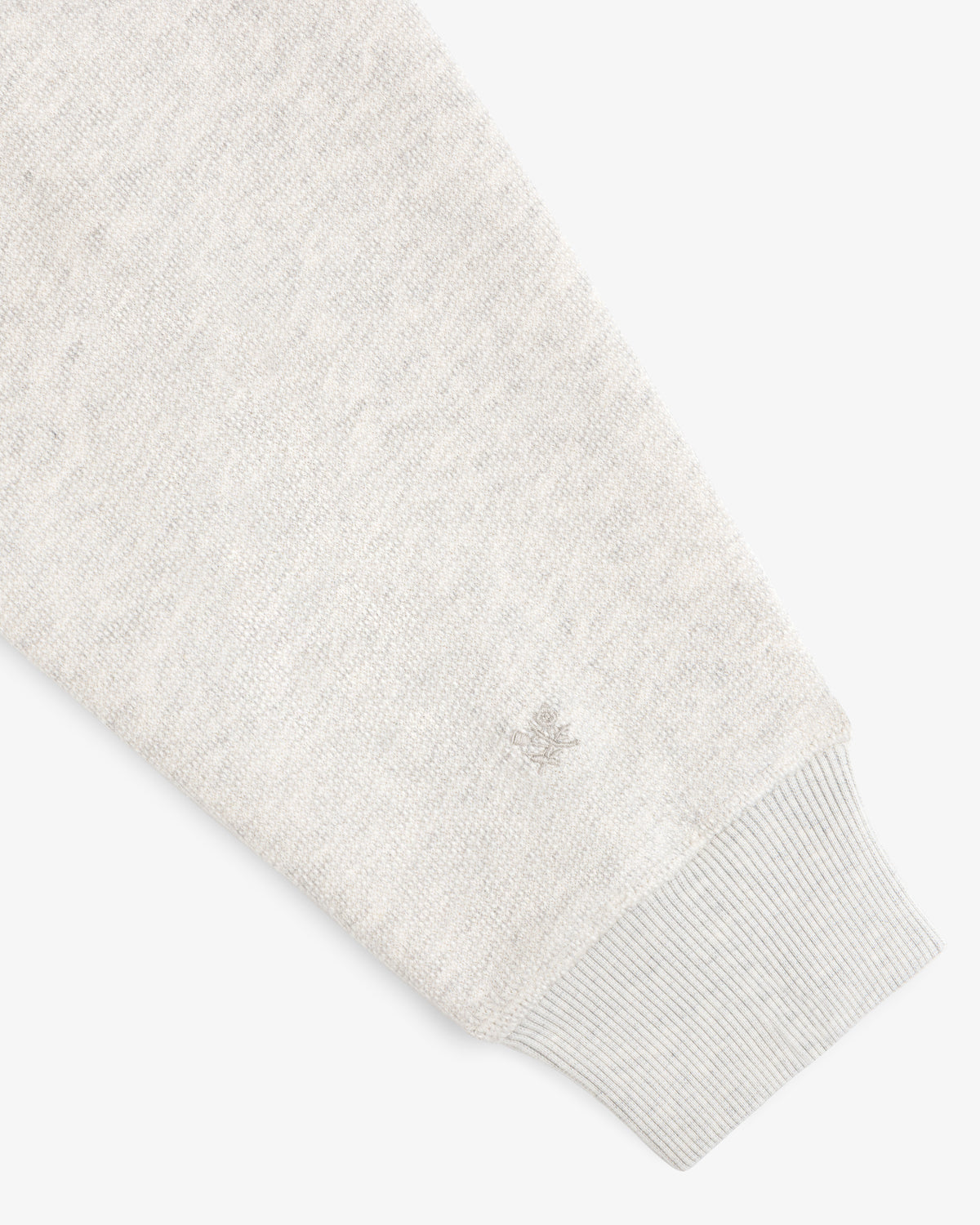 Stone Washed Marina Hoodie in light gray knit, long sleeves, ribbed cuffs, and small wrist logo embroidery.
