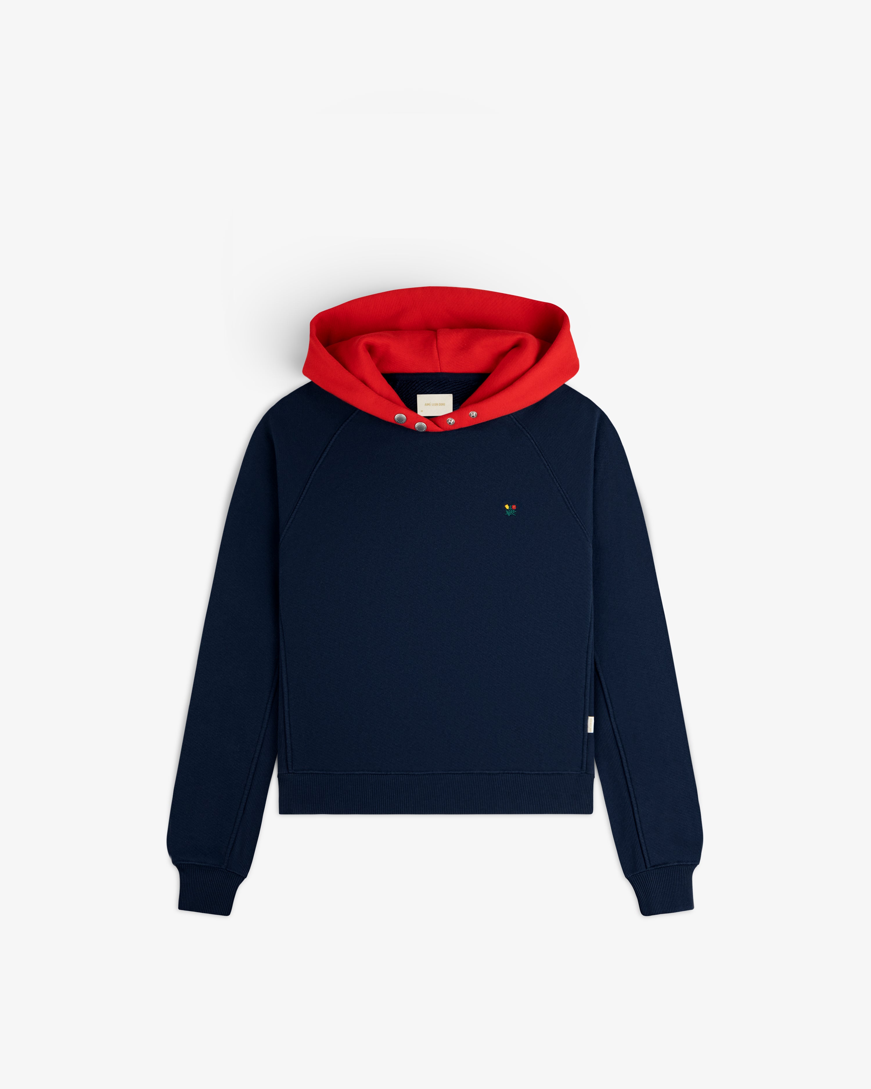 Colorblock Crest Snap Hoodie: a navy blue long-sleeved pullover with a red hood and snap buttons at the neck.