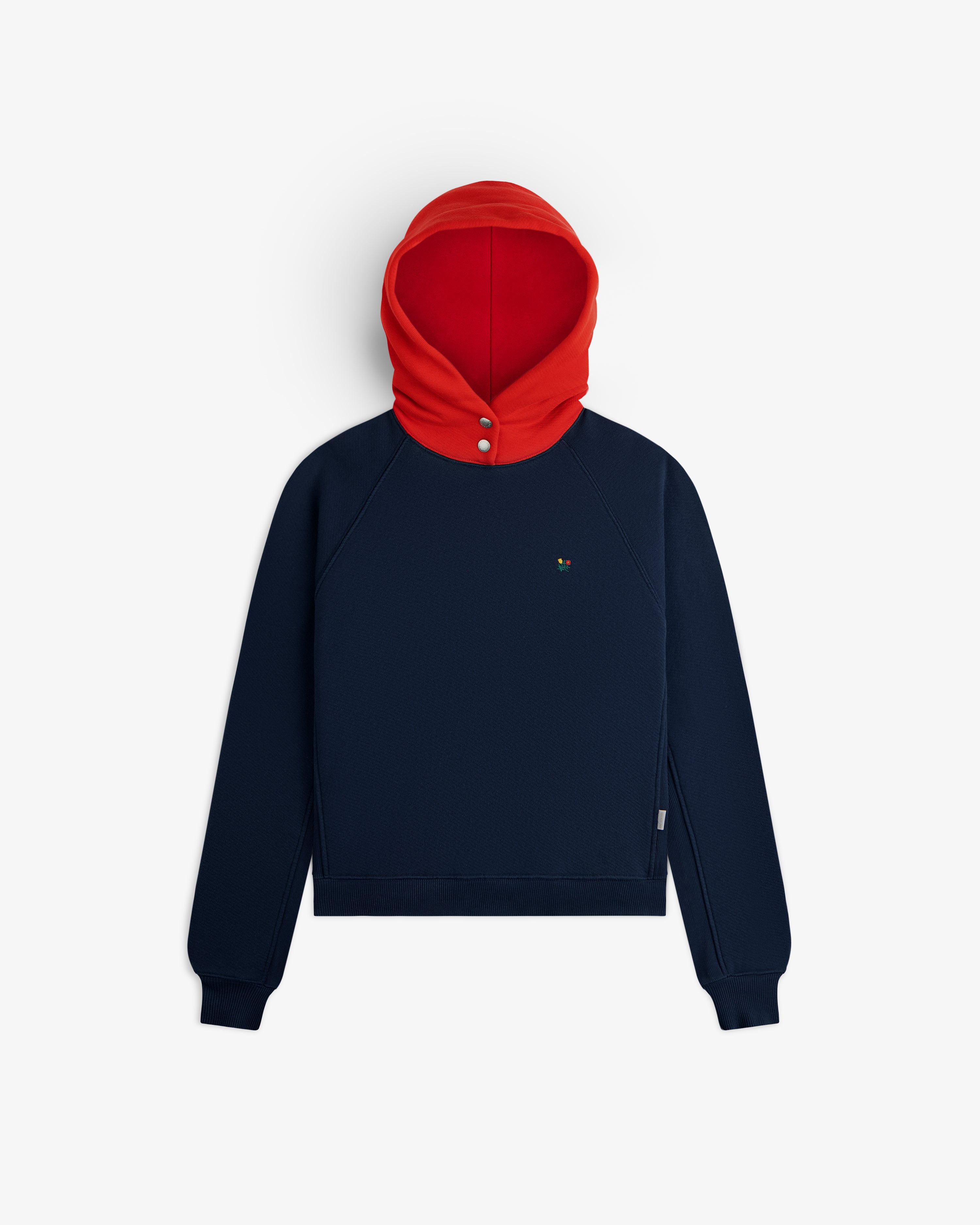 Colorblock Crest Snap Hoodie in navy blue with a red hood and two silver snap buttons at the neck.