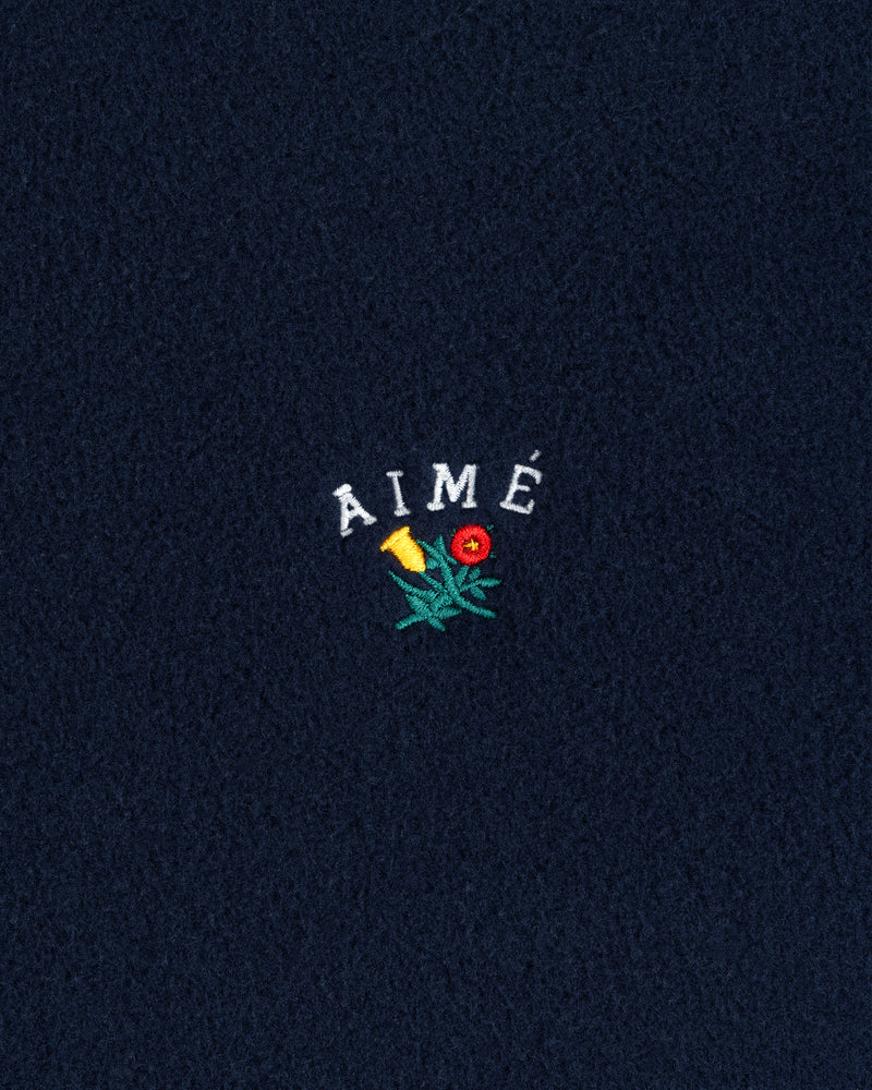 Navy Crest Fleece Full-Zip Hoodie with AIMÉ text and a small embroidered yellow-red flower with green leaves.