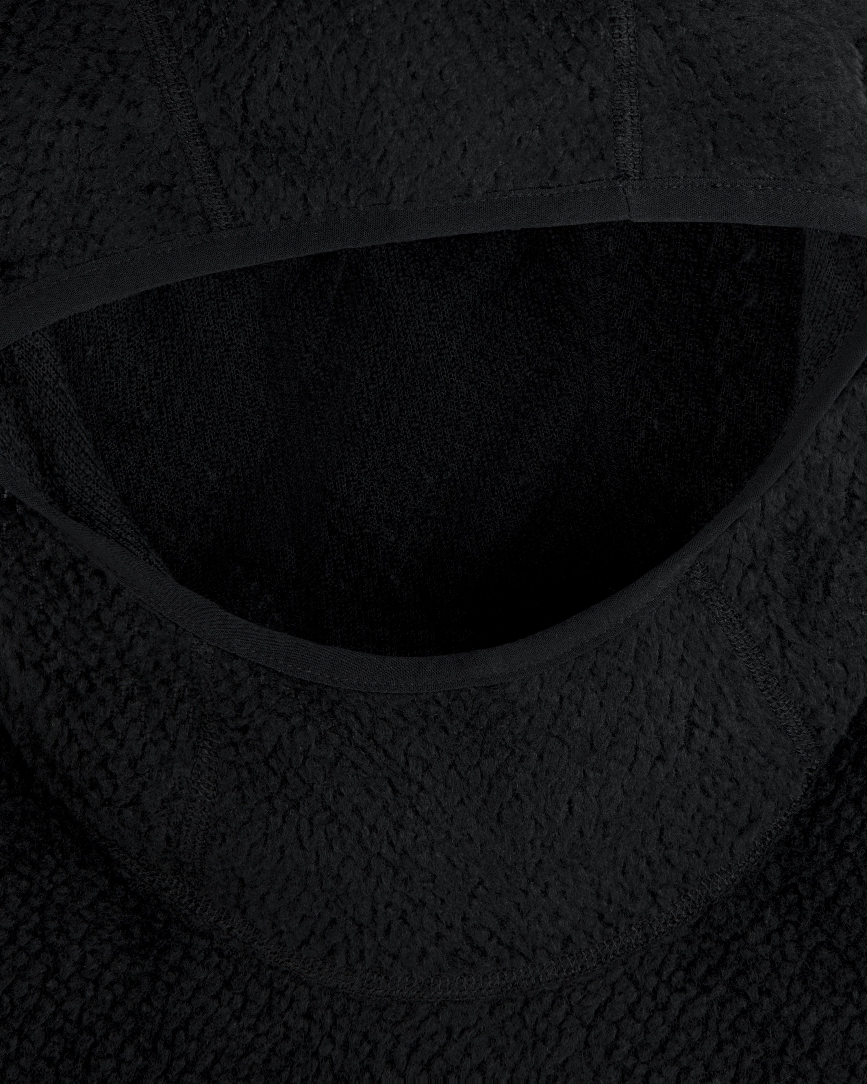Close-up of a black textured Fleece Performance Hoodie hood with smooth fabric trim.