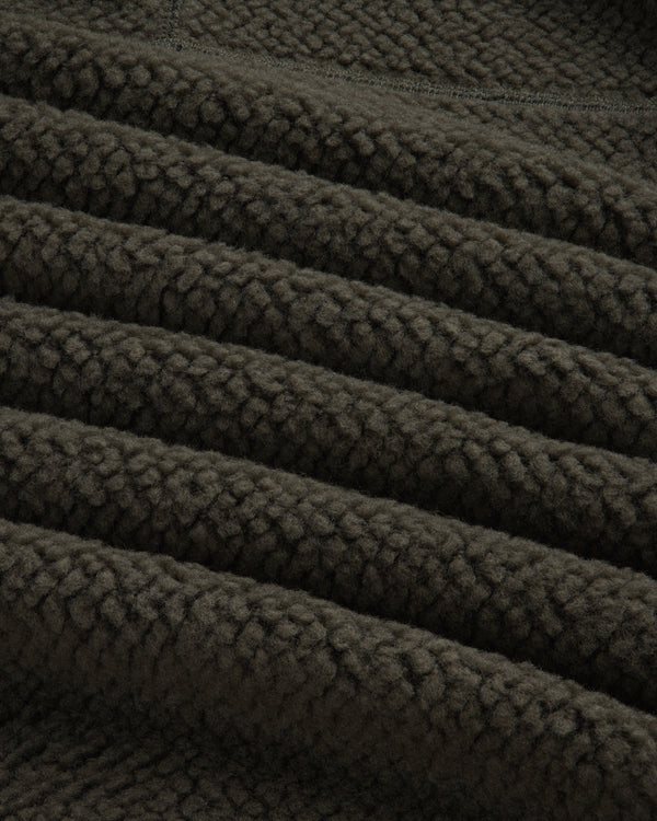 Close-up of the textured dark olive green fabric of a Fleece Performance Hoodie.