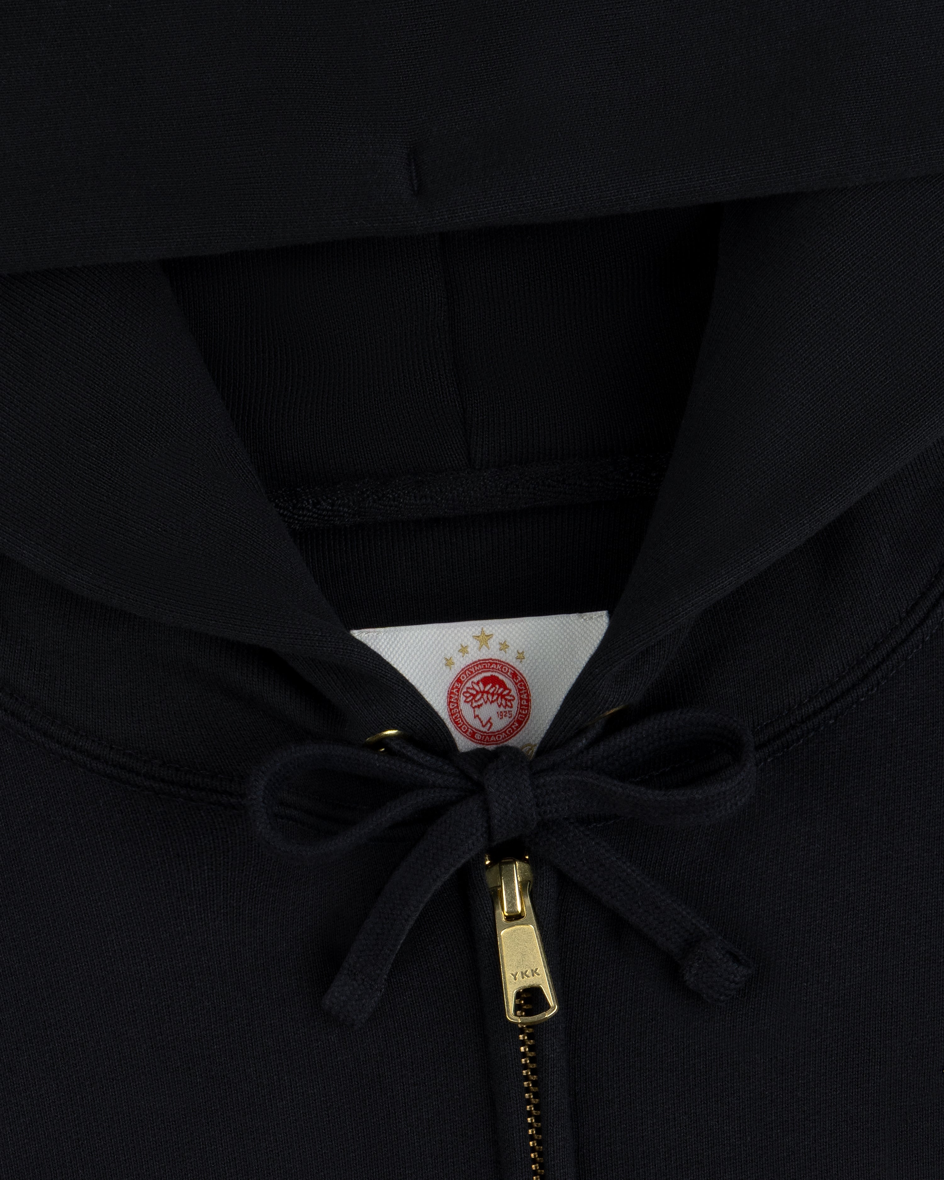 ALD / Olympiacos F.C. Full Zip Hoodie in black with a gold zipper and a circular team logo on the interior neck label.