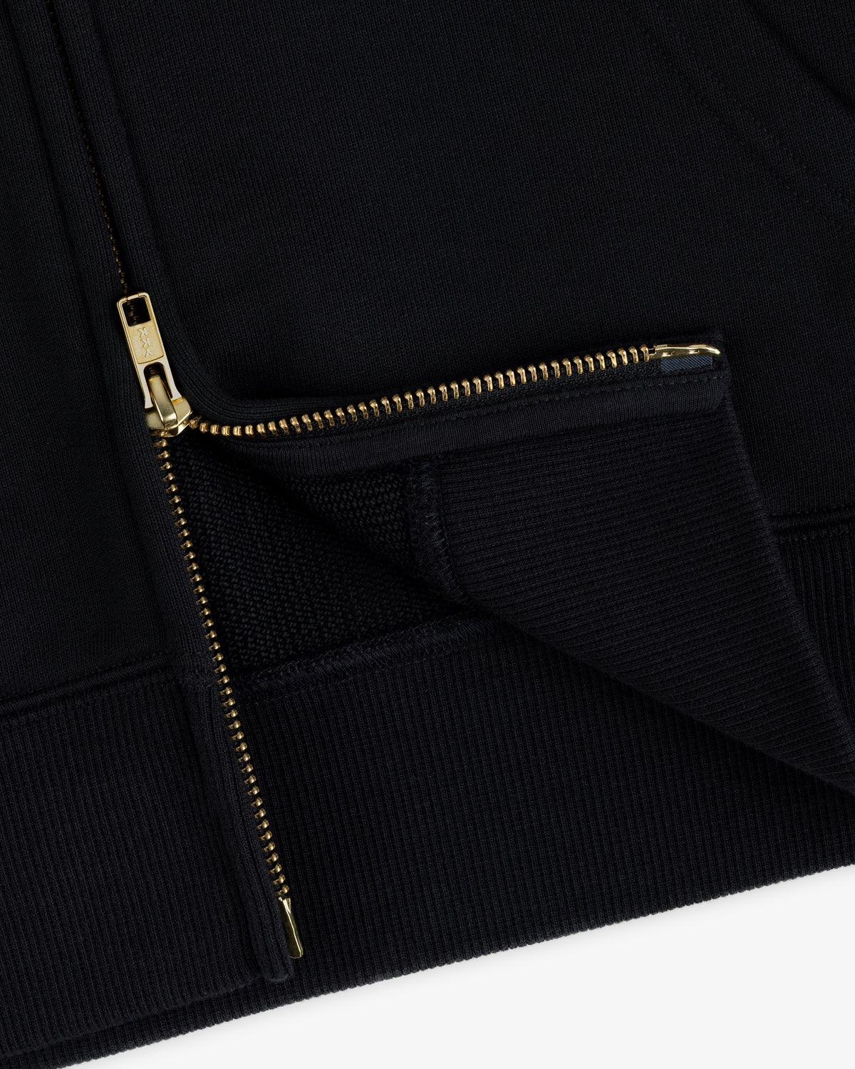 Close-up of a black ALD / Olympiacos F.C. Full Zip Hoodie with a gold-toned metal zipper.