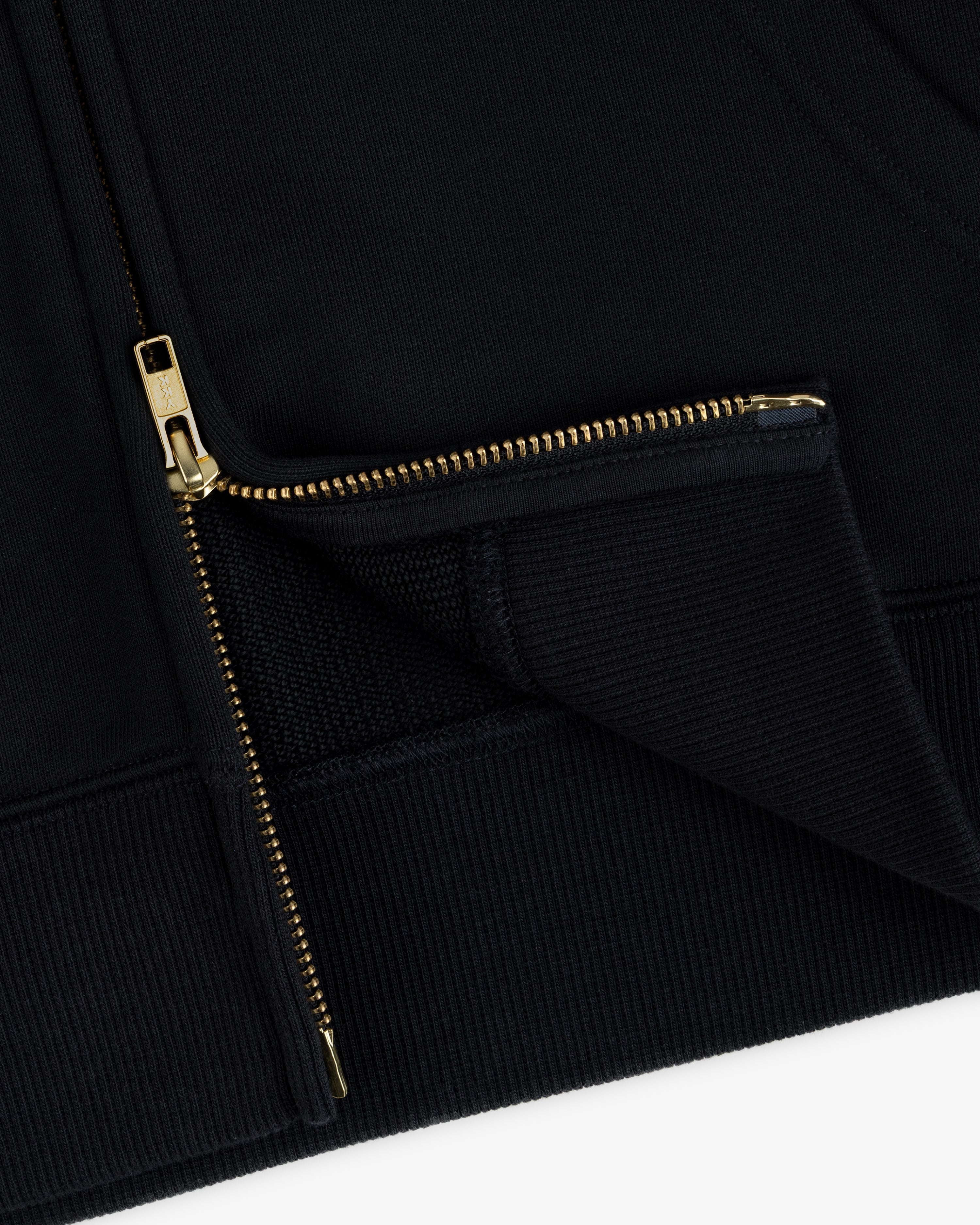 Close-up of a black ALD / Olympiacos F.C. Full Zip Hoodie with a gold-toned metal zipper.