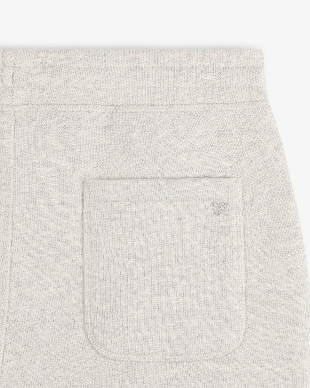 Close-up of the back pocket on Stone Washed Marina Sweatpants with a subtle embroidered logo above the pocket.
