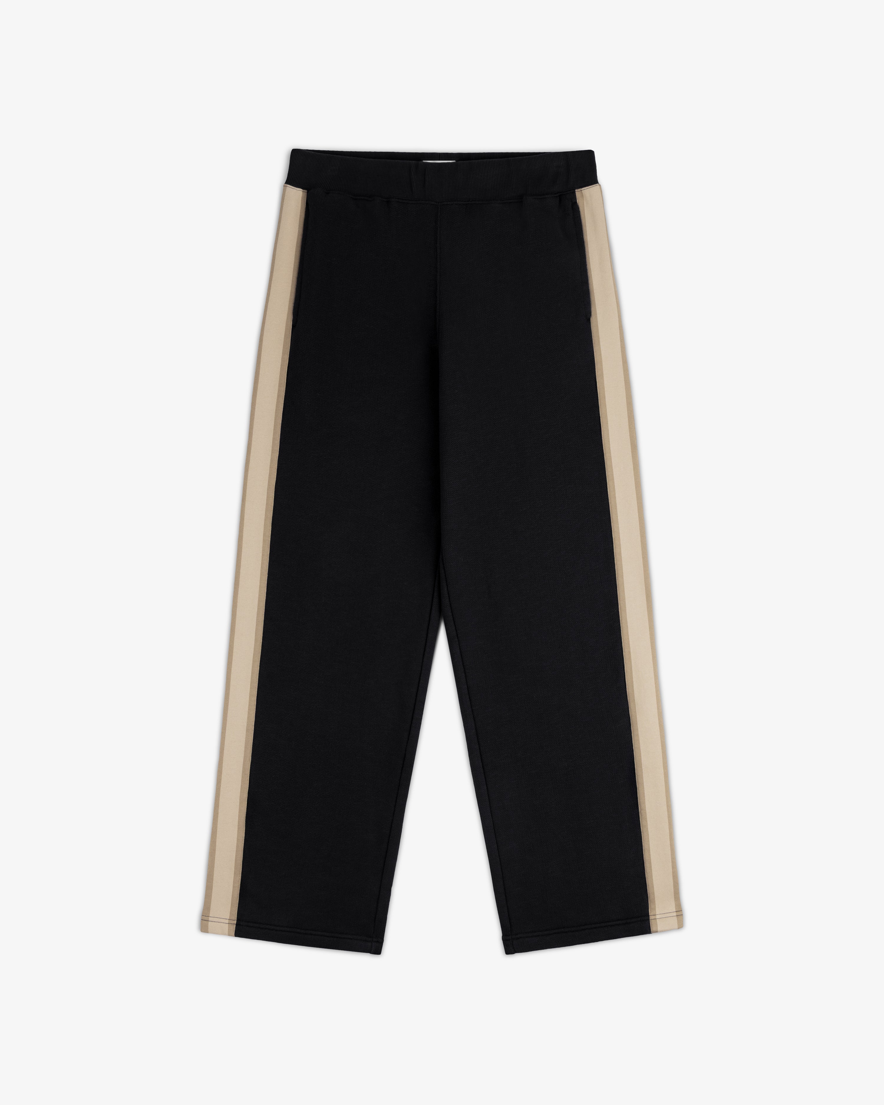 Saint George Track Pant: black with wide beige side stripes, elastic waist, straight legs, shown flat on white background.