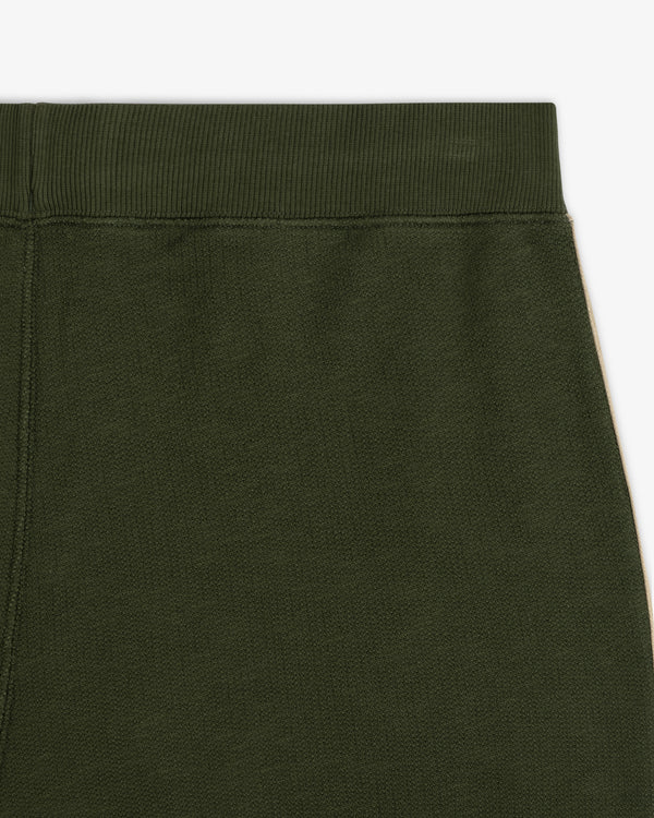 Close-up of the upper part of Saint George Track Pant in dark green with an elastic waistband.