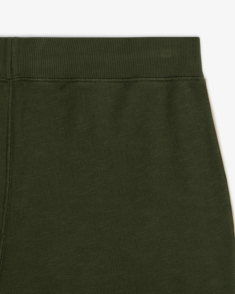 Close-up of the upper part of Saint George Track Pant in dark green with an elastic waistband.