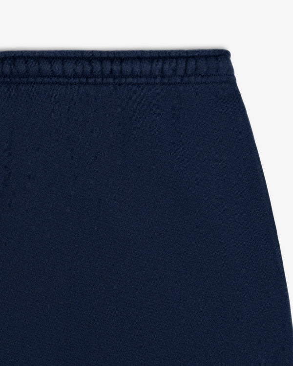 Close-up of a navy blue Script Sweatpant waistband with a ribbed texture.