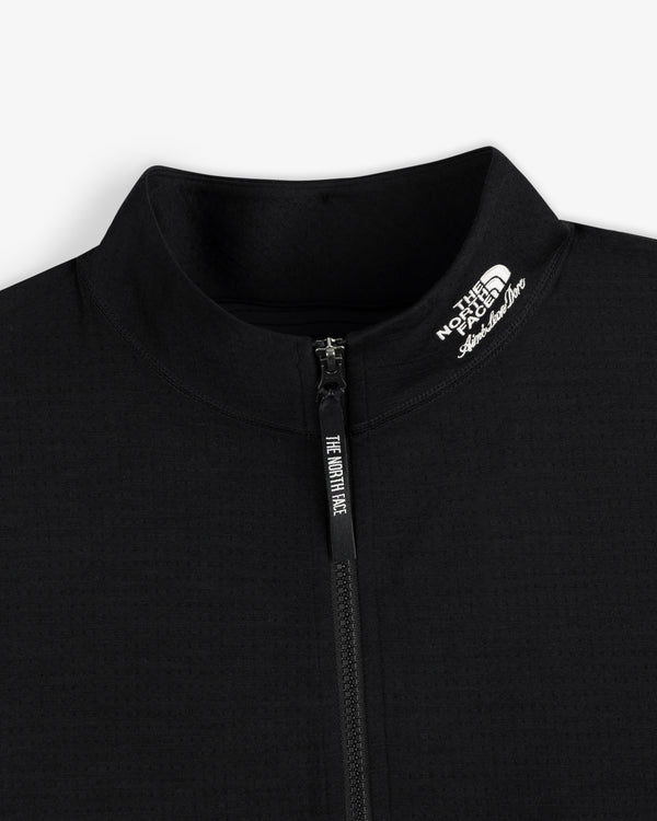 Close-up of a black ALD/The North Face DOTKNIT™ Wool Quarter Zip, logo on collar, on a white background.