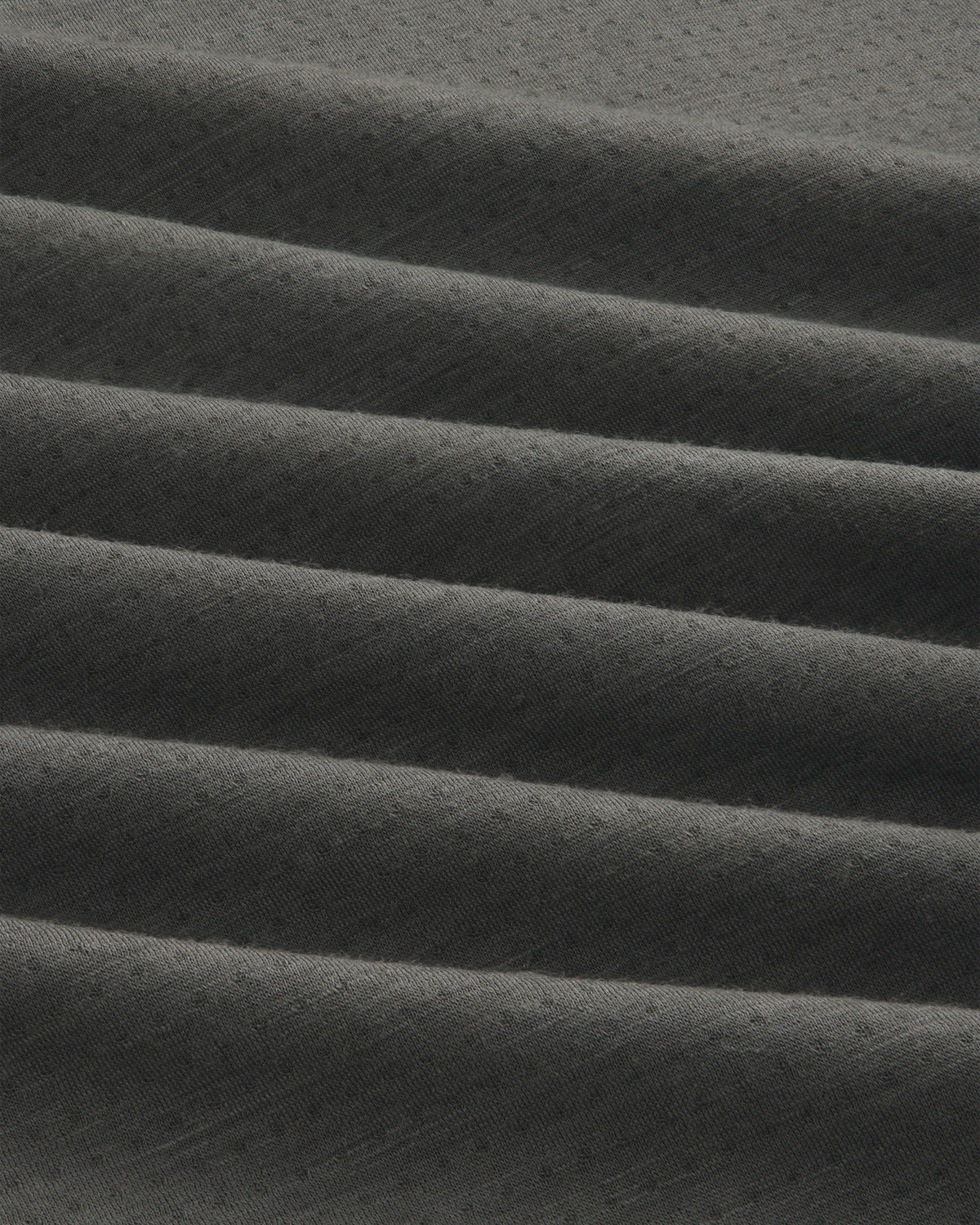 Dark gray ALD/The North Face DOTKNIT™ Wool Quarter Zip with subtle textured fabric in horizontal pleats.