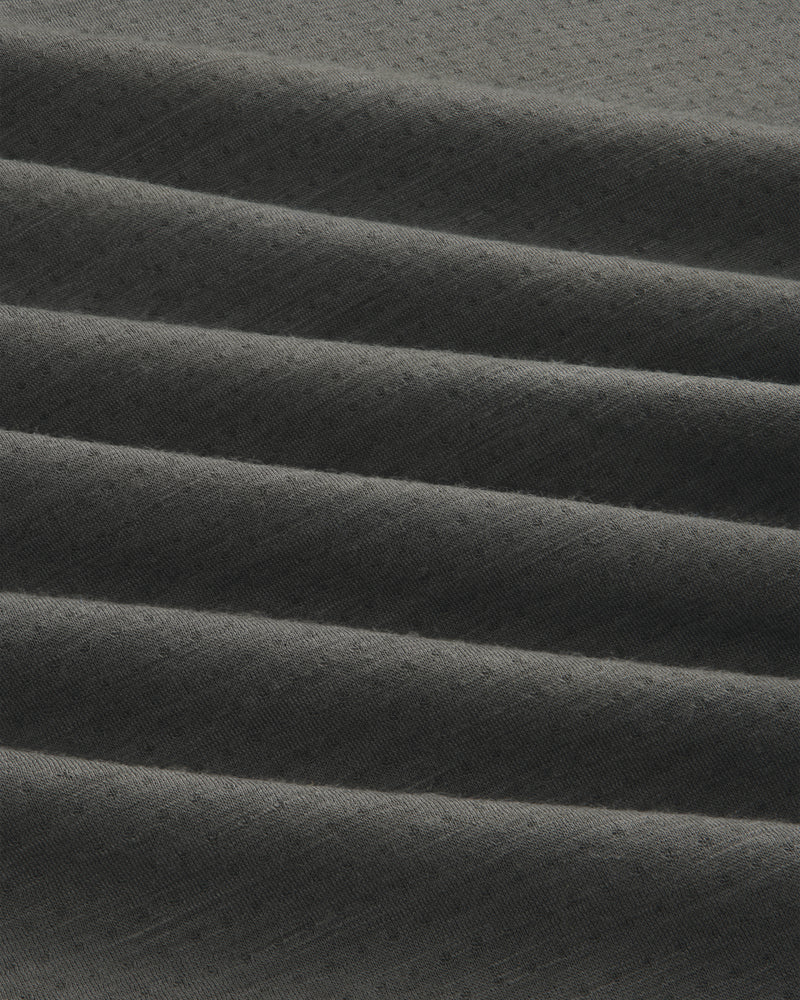 Dark gray ALD/The North Face DOTKNIT™ Wool Quarter Zip with subtle textured fabric in horizontal pleats.