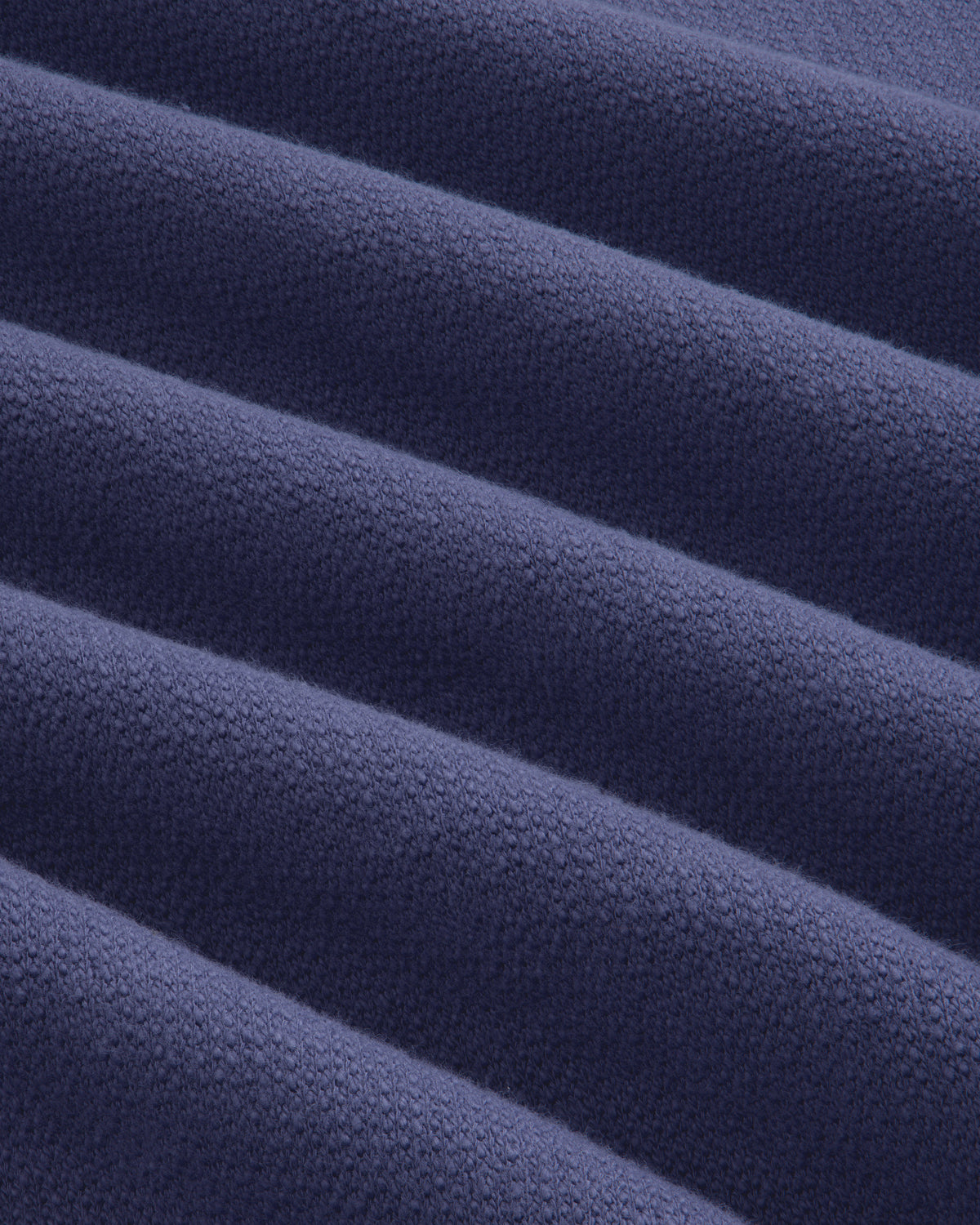 Close-up of soft, ribbed texture on Stone Washed Marina Crewneck Sweatshirt in dark blue with raised lines.