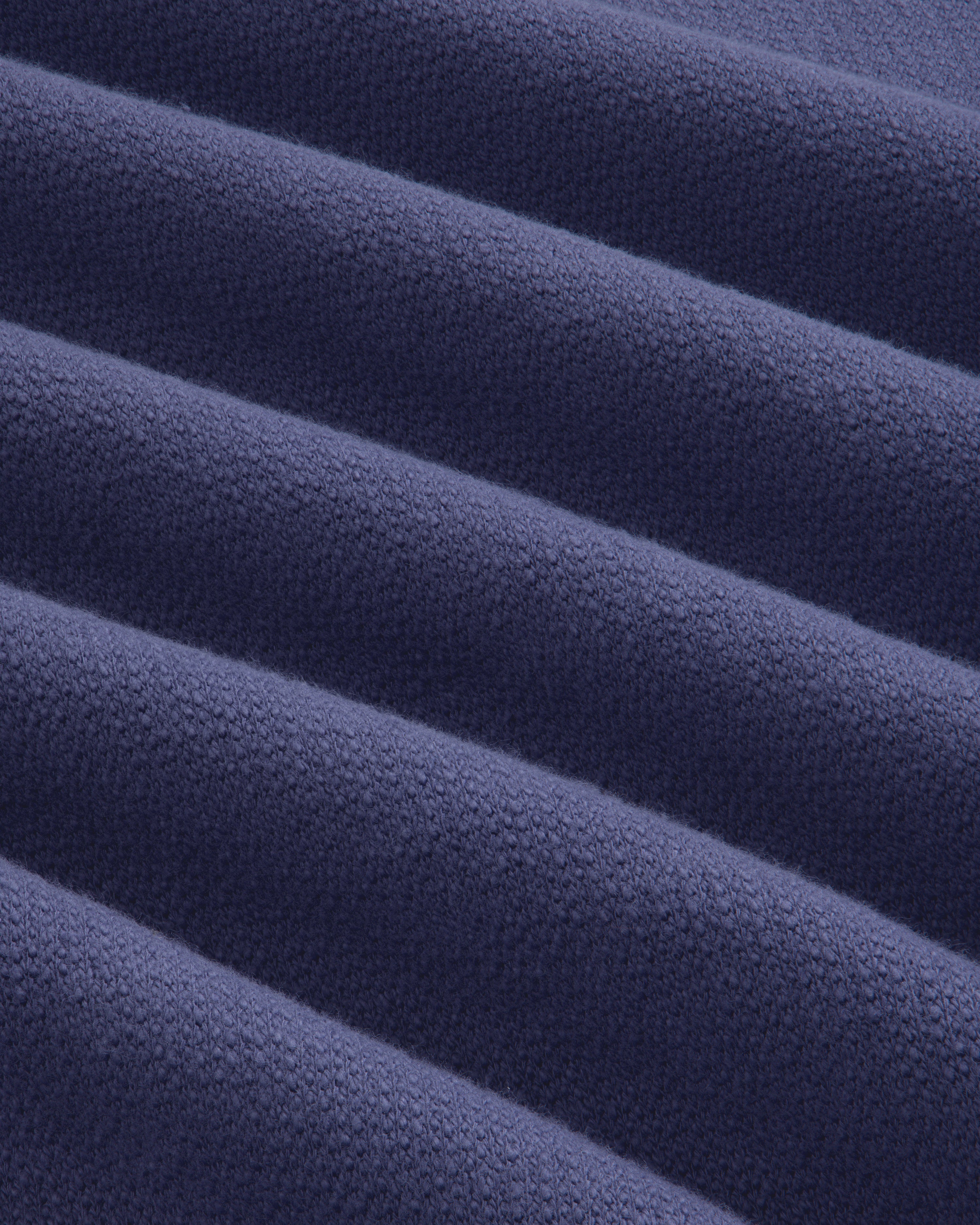 Close-up of soft, ribbed texture on Stone Washed Marina Crewneck Sweatshirt in dark blue with raised lines.