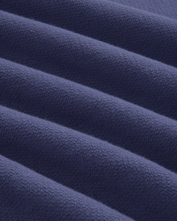 Close-up of soft, ribbed texture on Stone Washed Marina Crewneck Sweatshirt in dark blue with raised lines.
