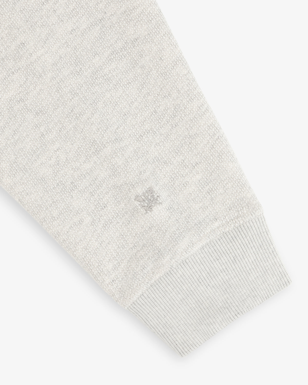 Stone Washed Marina Crewneck sleeve with ribbed cuff, textured fabric, and small logo embroidery near the wrist.