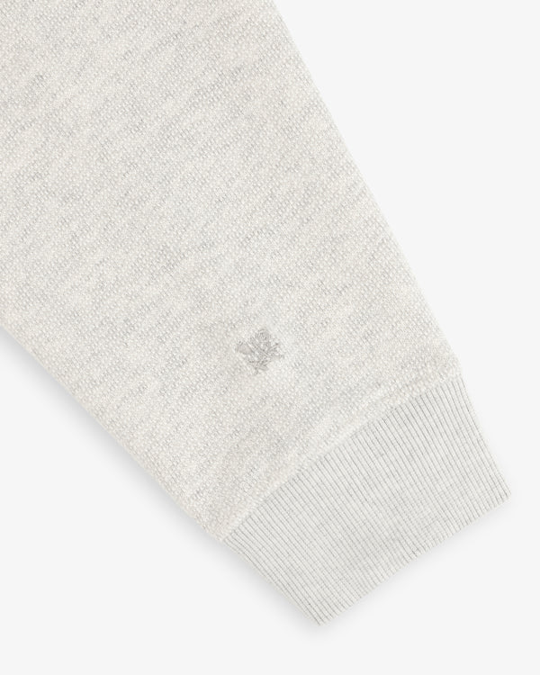 Stone Washed Marina Crewneck sleeve with ribbed cuff, textured fabric, and small logo embroidery near the wrist.