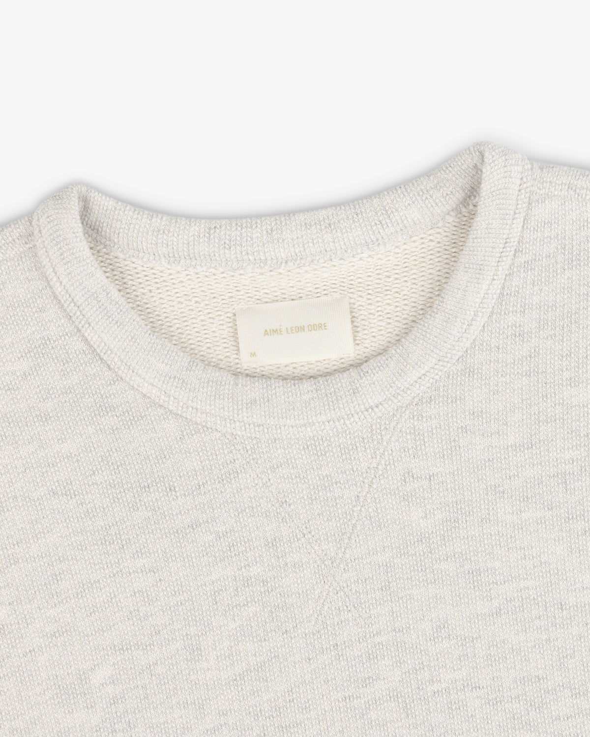 Stone Washed Marina Crewneck Sweatshirt in light gray with visible texture and an inside white Aimé Leon Dore label.