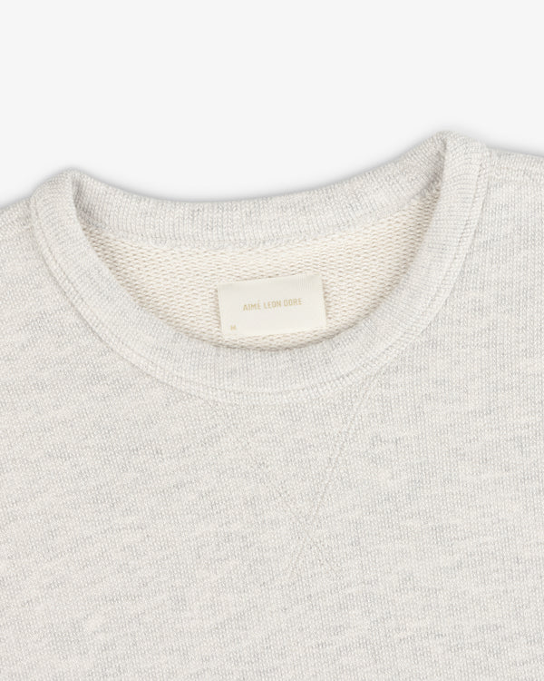 Stone Washed Marina Crewneck Sweatshirt in light gray with visible texture and an inside white Aimé Leon Dore label.
