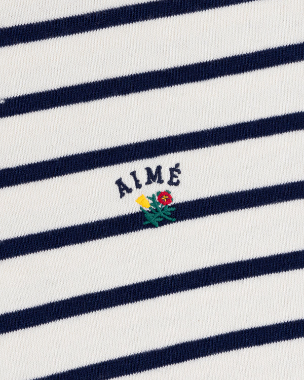 Striped Crest Quarter Zip: White with navy stripes, AIMÉ text, and small yellow/red embroidered flowers below.