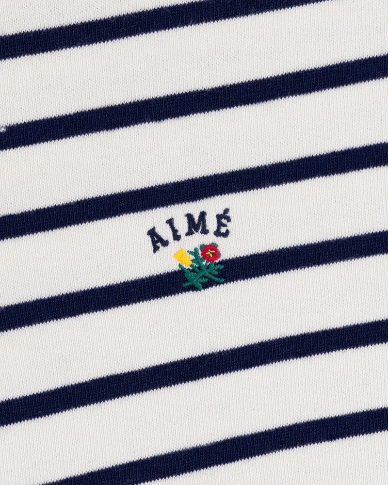 Striped Crest Quarter Zip: White with navy stripes, AIMÉ text, and small yellow/red embroidered flowers below.