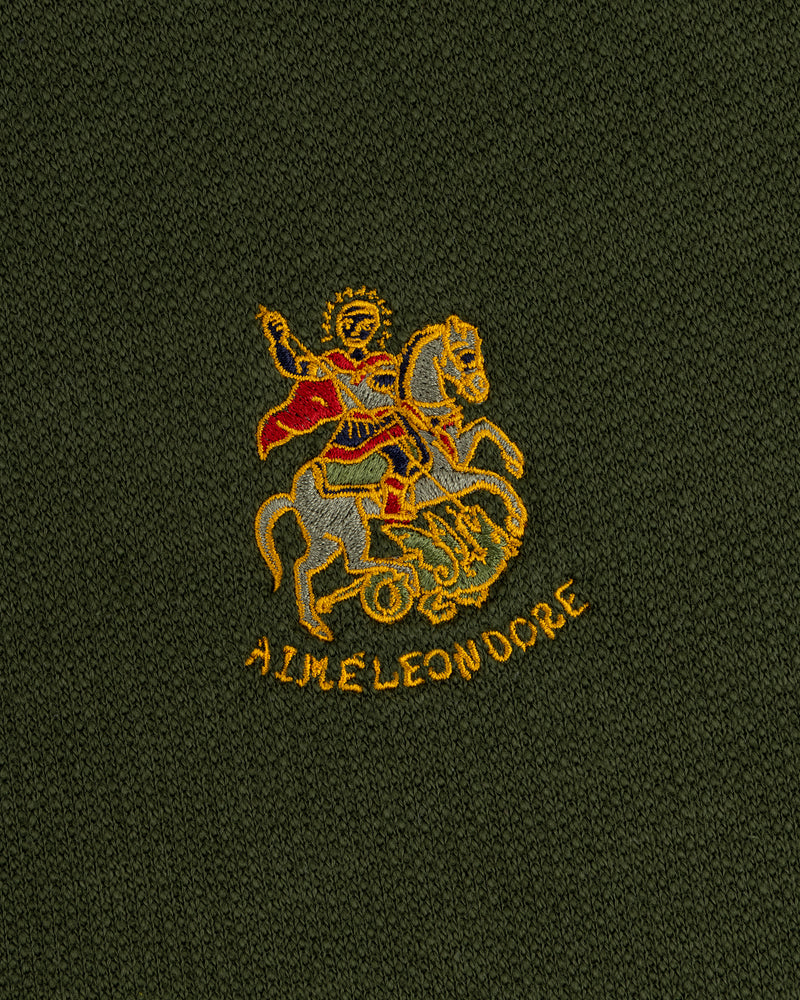 Saint George Track Jacket: Embroidered rider in red cape over yellow AIME LEON DORE text on dark green fabric.