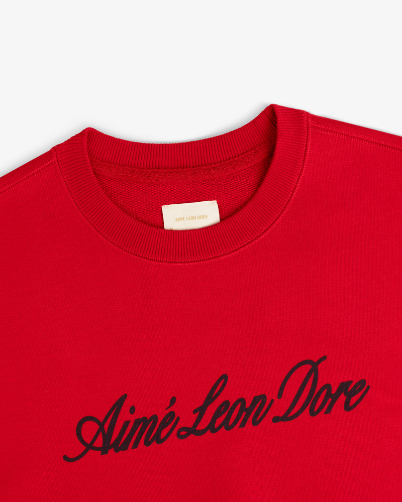 Red Vintage Script Crewneck Sweatshirt featuring Aimé Leon Dore in black script across the chest.