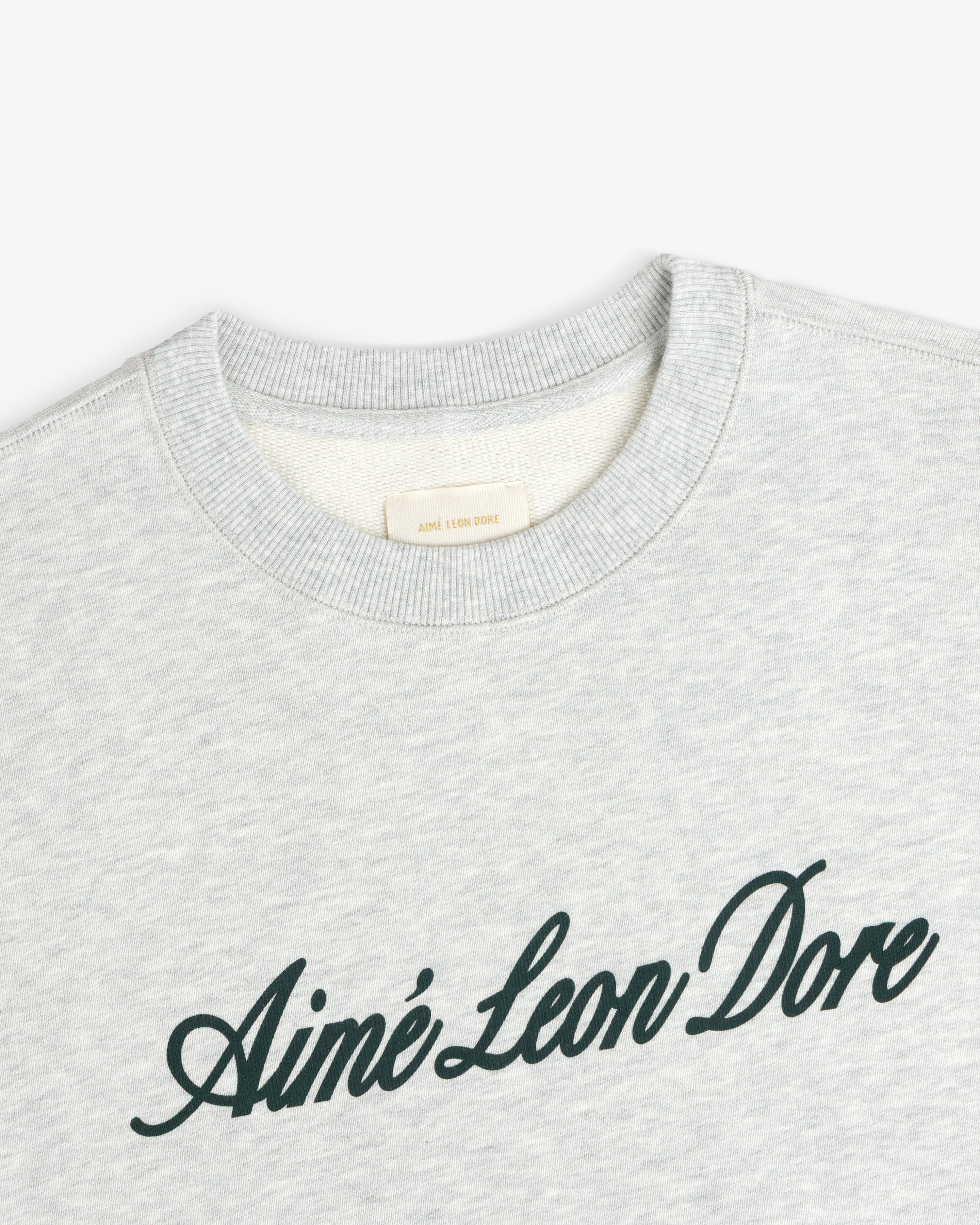 Light gray Vintage Script Crewneck Sweatshirt with Ainé Leon Dore in dark script across the chest.