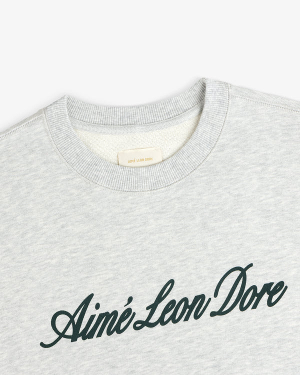 Light gray Vintage Script Crewneck Sweatshirt with Ainé Leon Dore in dark script across the chest.