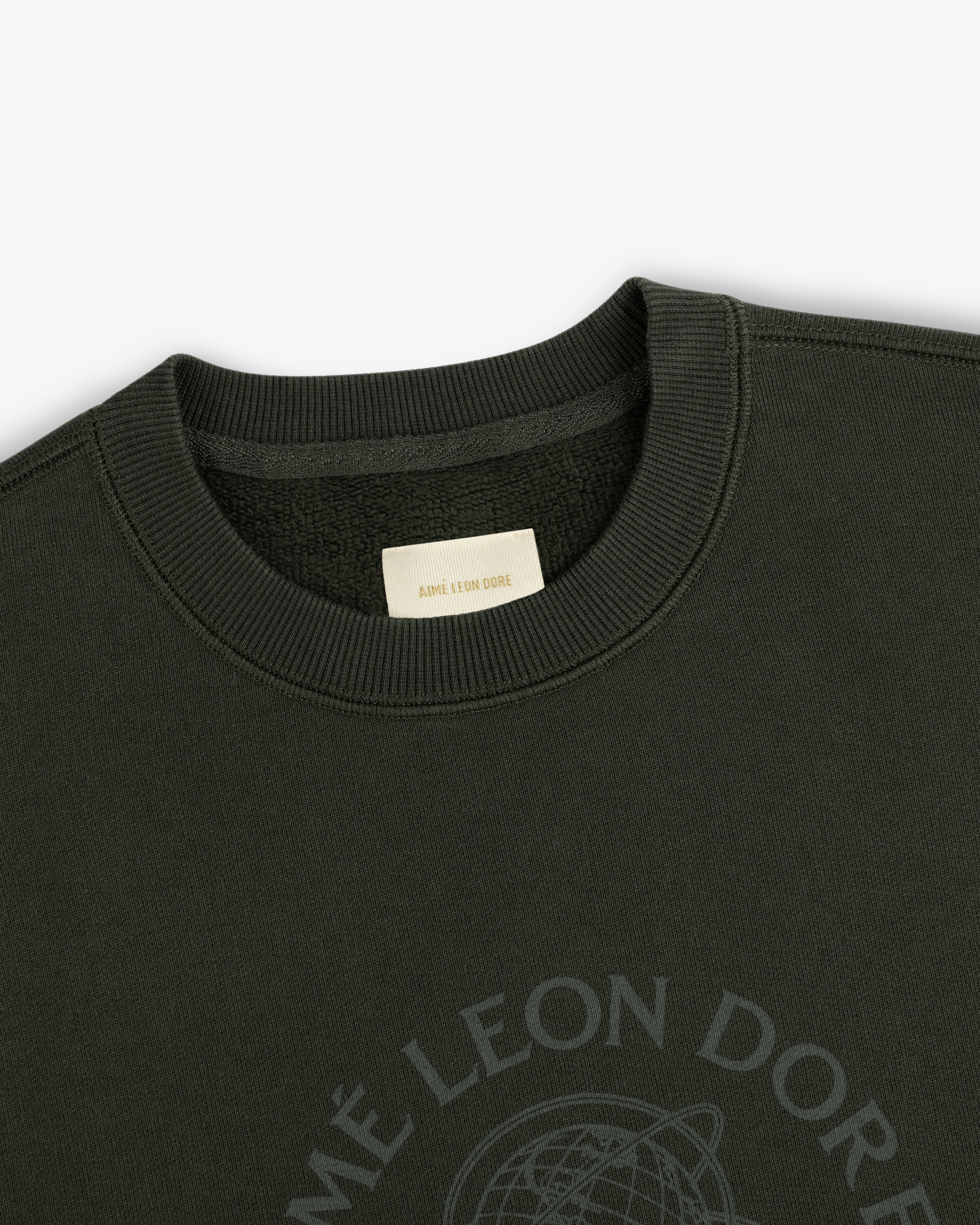 Dark olive Atlas Crewneck Sweatshirt featuring a circular chest logo and an interior brand label.