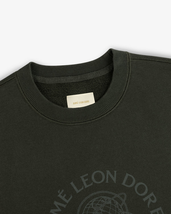 Dark olive Atlas Crewneck Sweatshirt featuring a circular chest logo and an interior brand label.