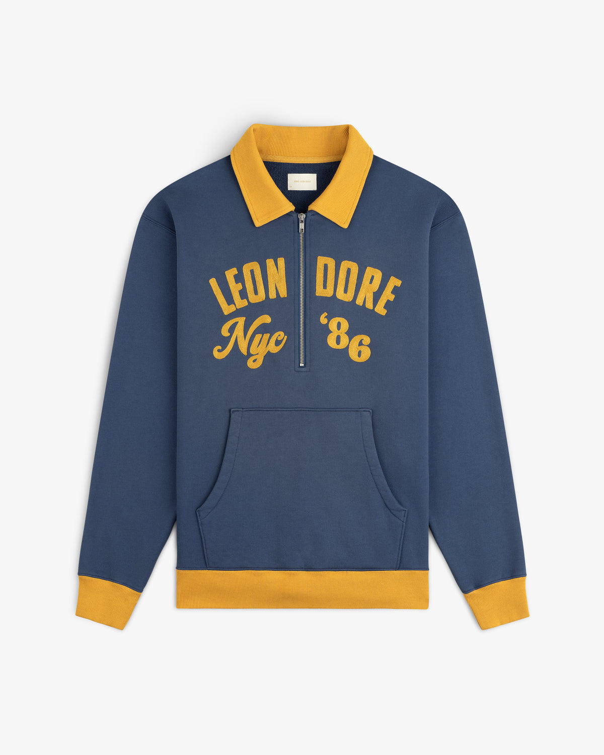 Chainstitch ’86 Half Zip Pullover in navy blue with a yellow collar, cuffs, hem, and gold embroidered chest text.