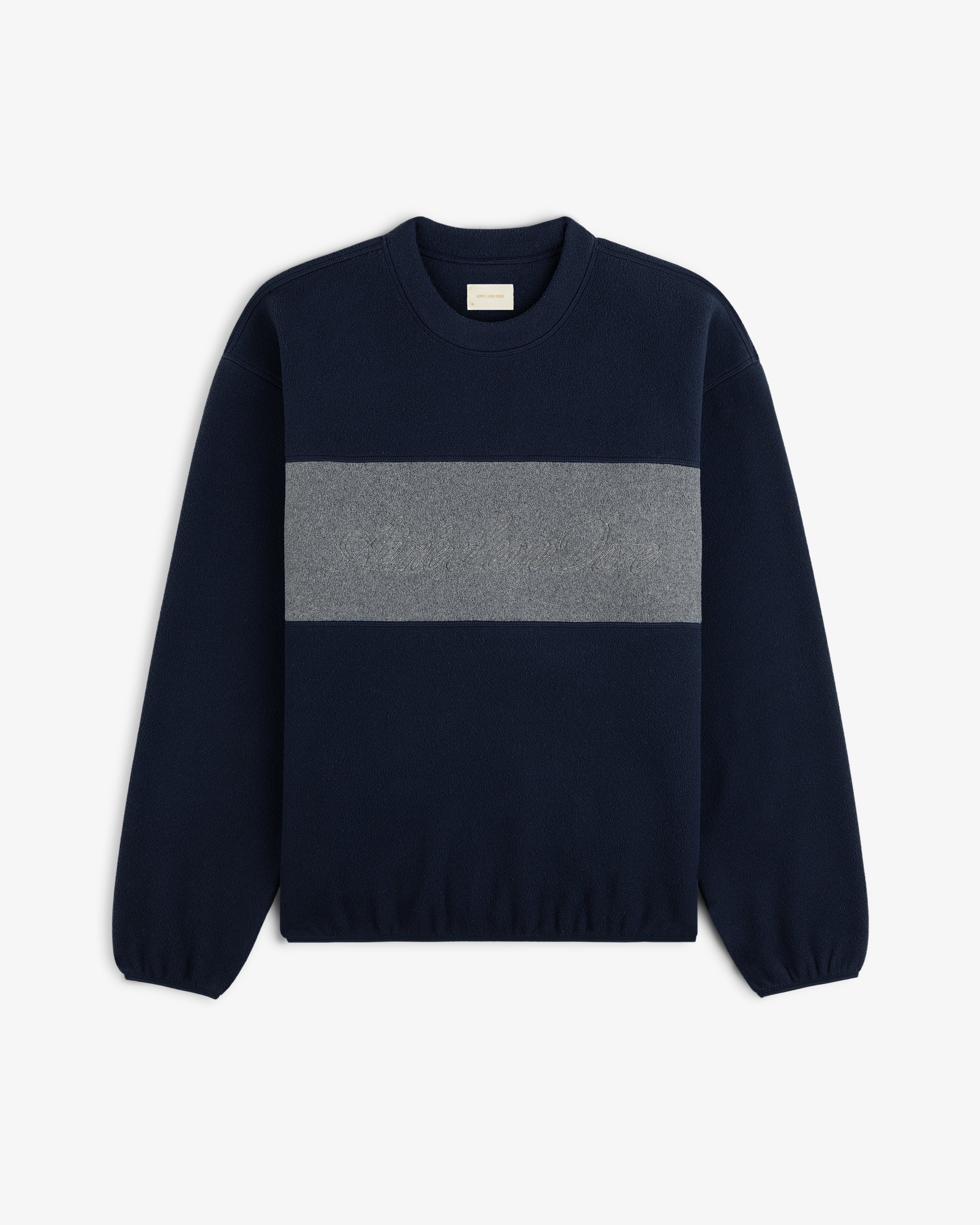 Fleece Script Paneled Crewneck Sweatshirt in navy blue with a wide grey chest panel and tonal script embroidery.