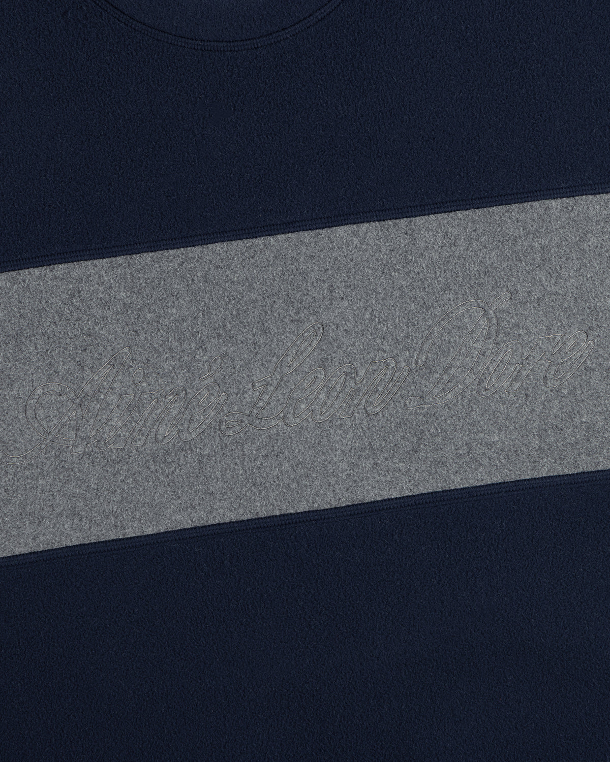 Fleece Script Paneled Crewneck Sweatshirt in navy blue with a wide grey chest panel featuring embossed script text.