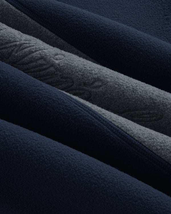 Close-up of a Fleece Script Paneled Crewneck Sweatshirt showing navy and grey fleece panels with embroidered lettering.
