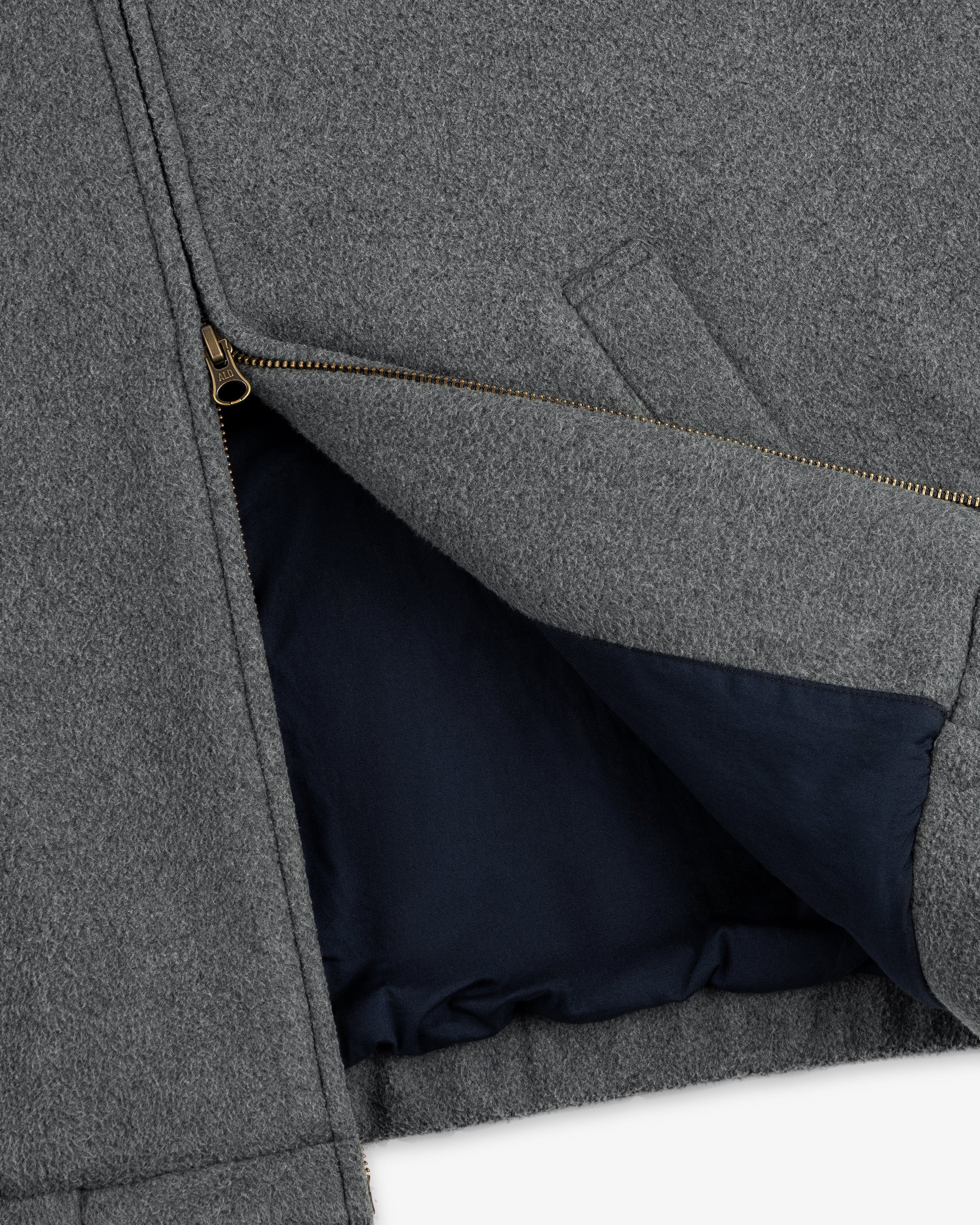 Close-up of the Crest Fleece Casual Jacket in gray with a brass zipper and dark navy lining visible inside.