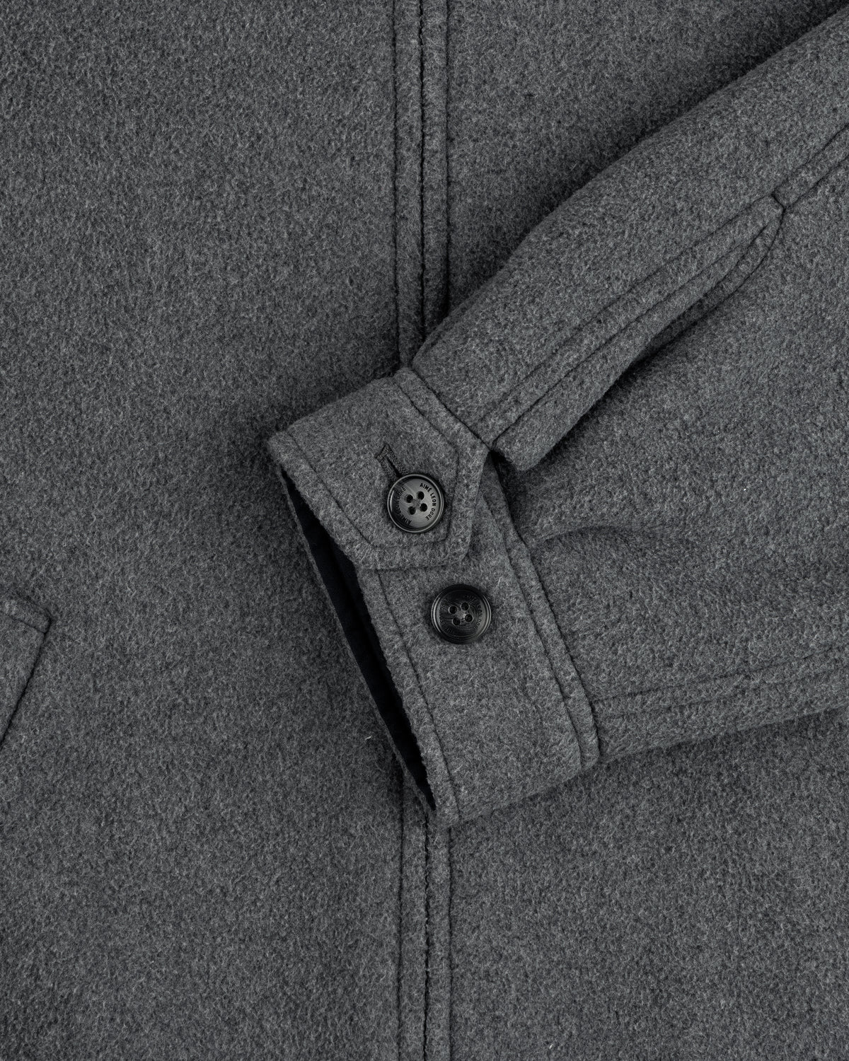 Close-up of Crest Fleece Casual Jacket sleeve in gray, featuring two black buttons and a partial view of pocket.