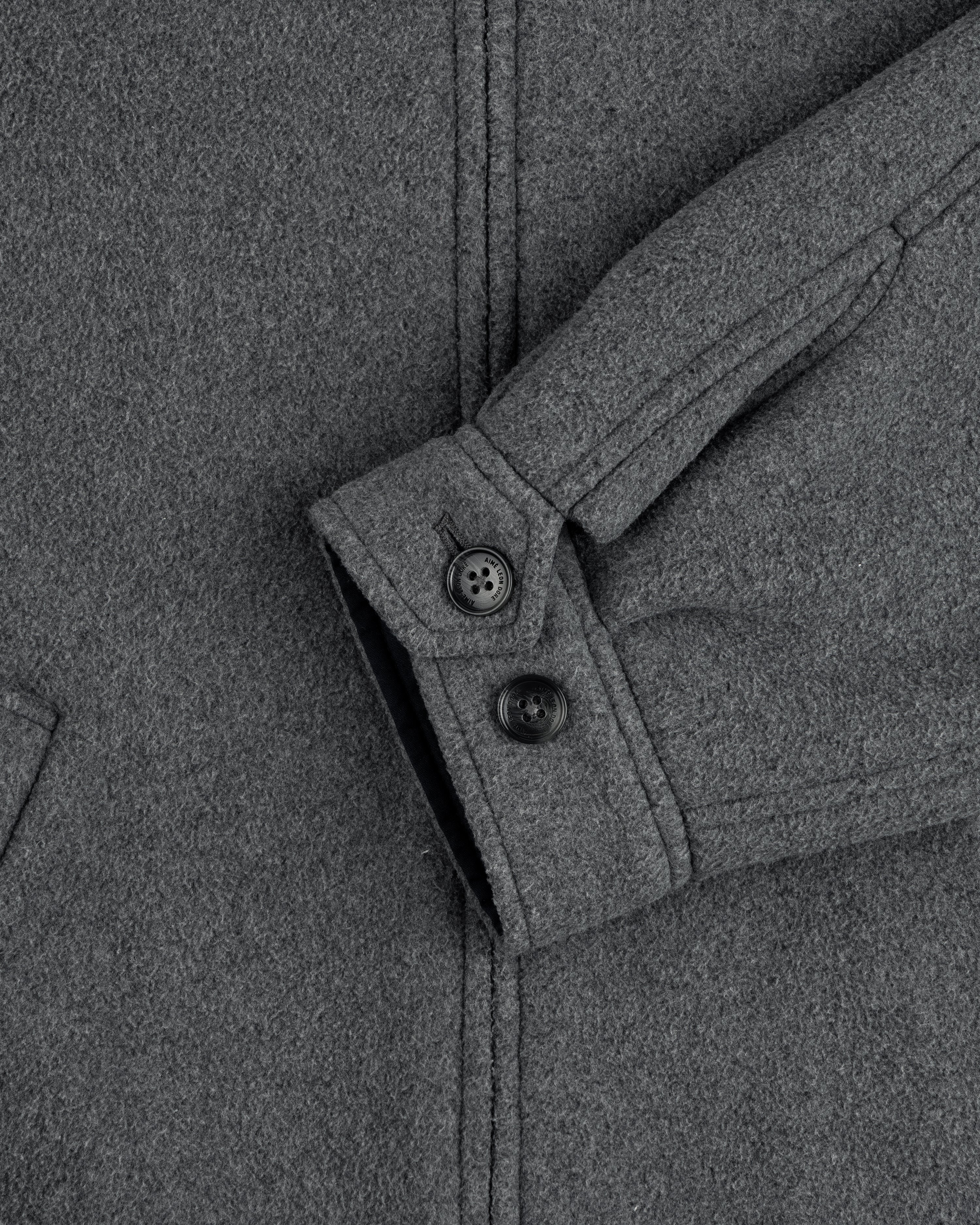 Close-up of Crest Fleece Casual Jacket sleeve in gray, featuring two black buttons and a partial view of pocket.