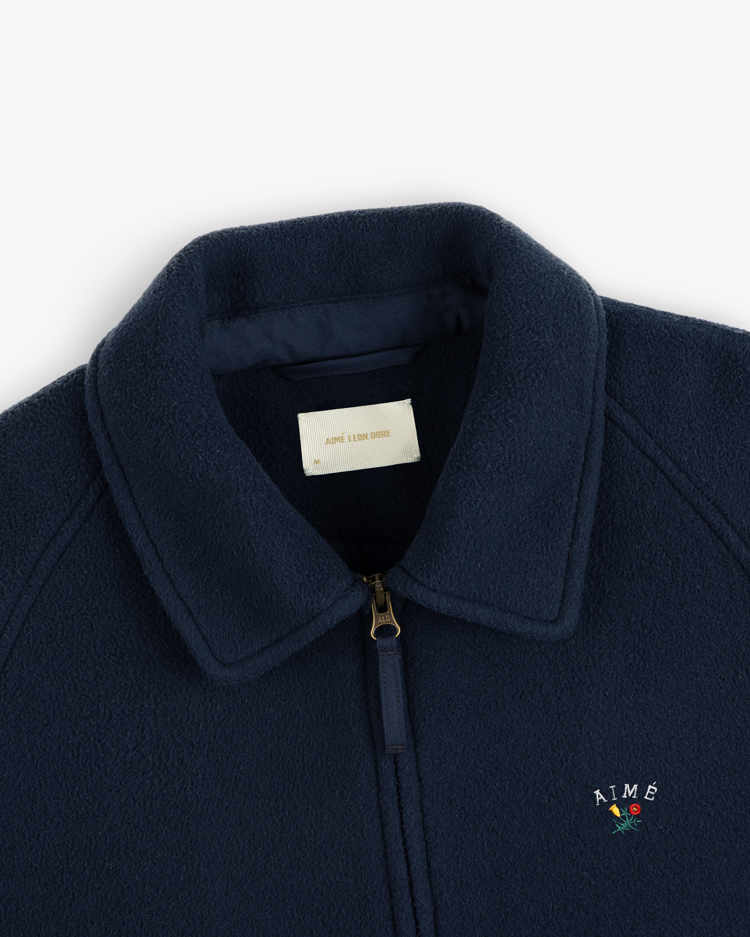 Crest Fleece Casual Jacket: Navy blue with gold zipper, collar, and AIMÉ + rose embroidery on chest.