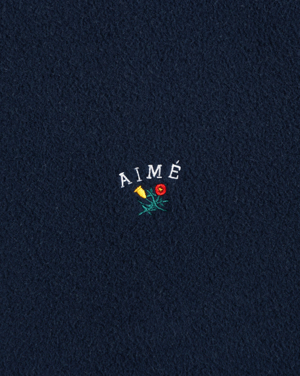 Navy Crest Fleece Casual Jacket with AIMÉ embroidered above a yellow and red flower on the center.